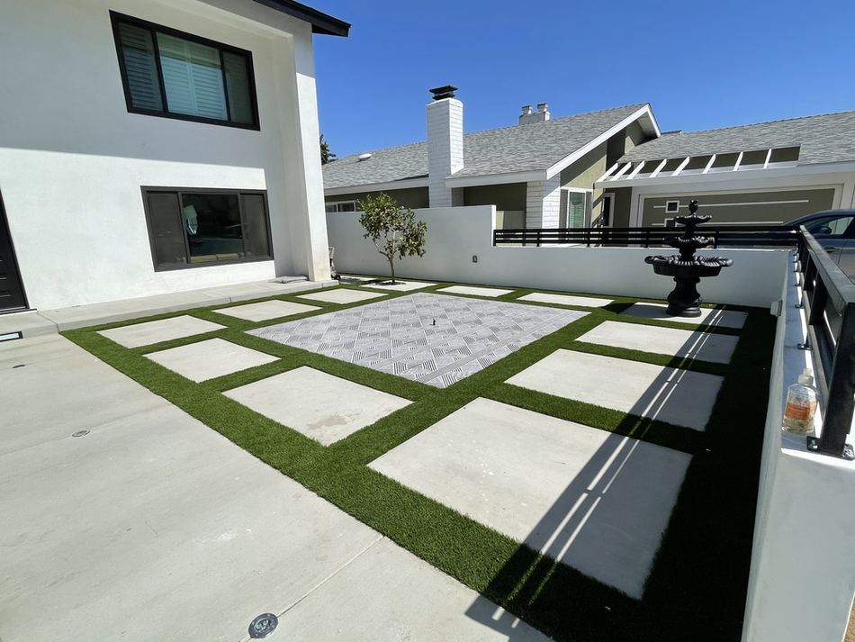 Finished concrete and turf front yard